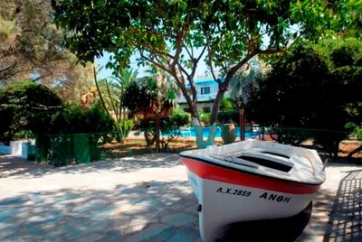 a boat sitting on the ground in a driveway at Kalives Apartments in Kalyves