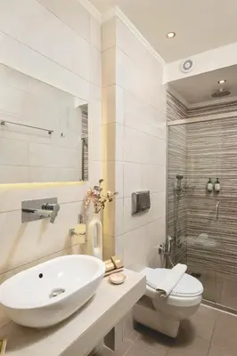 a bathroom with a sink and a toilet and a shower at Elia Palazzo Hotel in Chania Town
