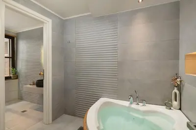 a bathroom with a tub and a walk in shower at Elia Palazzo Hotel in Chania Town