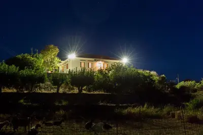a house lit up at night with two lights at Villa Alexandra in Kissamos