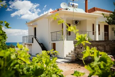 a white house with a view of the ocean at Villa Alexandra in Kissamos