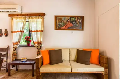 a living room with a couch with orange pillows at Aadonis traditional house on the Sea in Kolymvari