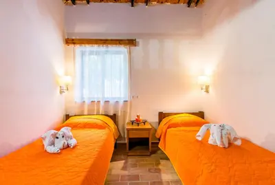 two beds with stuffed animals on them in a room at Aadonis traditional house on the Sea in Kolymvari