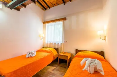 two beds in a room with towels on them at Aadonis traditional house on the Sea in Kolymvari