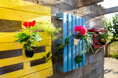 a wooden fence with potted plants and flowers on it at Aadonis traditional house on the Sea in Kolymvari