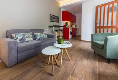a living room with a couch and two chairs and a table at Olive Garden Holiday Home steps to Beach 1 in Kato Daratso