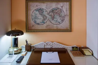 an office with a desk with a lamp and a map at Sali Chelidonaki boutique suite in Chania Town