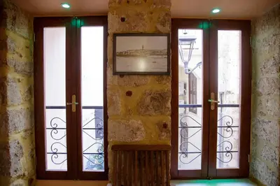 a room with three windows with a picture on the wall at Sali Chelidonaki boutique suite in Chania Town
