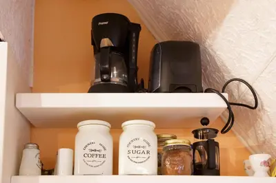 a shelf with coffee makers and a coffee maker at Sali Chelidonaki boutique suite in Chania Town