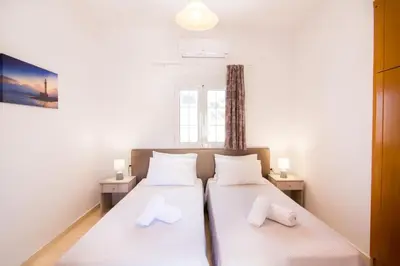 two twin beds in a room with a window at Cozy Renovated Apartment 