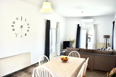 a living room with a table and chairs and a couch at Cozy Renovated Apartment 