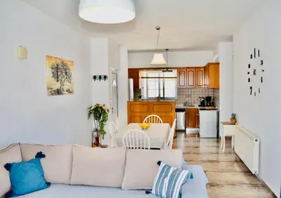 a living room with a couch and a kitchen at Cozy Renovated Apartment 