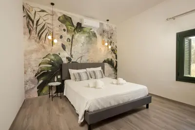 a bedroom with a bed with two pillows on it at Zen Villa Elafonisi in Kamára