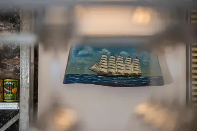 a painting of a ship on a wall at kito- transformed house on the water's edge in Chania Town