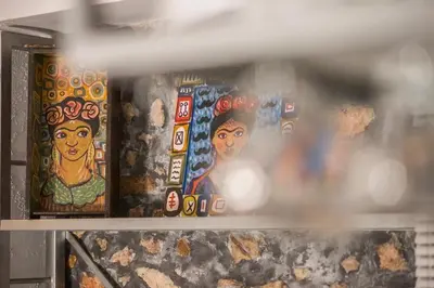 a shelf with paintings of women on it at kito- transformed house on the water's edge in Chania Town