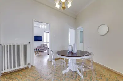 a dining room with a table and chairs at Samouil Apartment steps from the beach in Chania Town