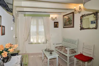 a living room with a chair and a window at Casa della Favola Boutique Hotel in Chania Town