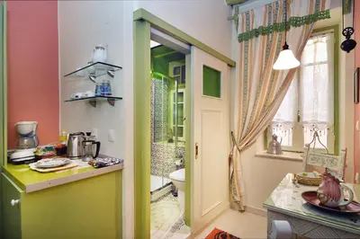 a kitchen with a sink and a toilet in a room at Casa della Favola Boutique Hotel in Chania Town