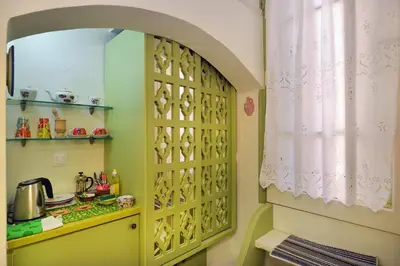 a kitchen with a large wooden cabinet in a room at Casa della Favola Boutique Hotel in Chania Town