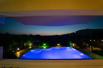 a large swimming pool at night with a purple sky at Golden Rose Suites in Kolymvari