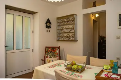 a dining room with a table with a bowl of fruit on it at Cottage home at South Chania in Grigorianá