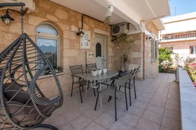 an outdoor patio with a table and chairs at Harmony House in Kissamos