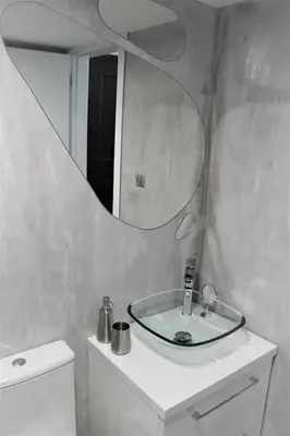 a bathroom with a sink and a mirror on the wall at Dali Rooms in Chania Town