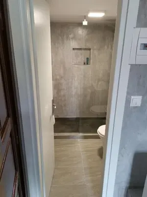 a bathroom with a toilet and a glass shower at Dali Rooms in Chania Town
