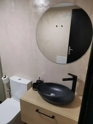 a bathroom with a black sink and a mirror at Dali Rooms in Chania Town