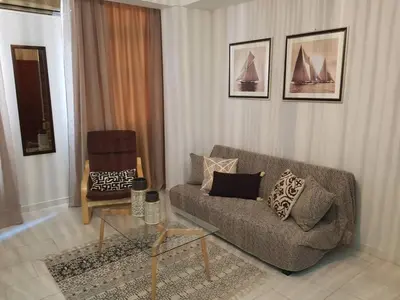 a living room with a couch and a chair at Dali Rooms in Chania Town