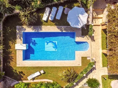 an overhead view of a swimming pool with an umbrella at Niko's art Villa in Chania in Perivólia