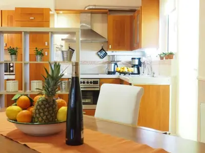 a kitchen with a bowl of fruit on a table at Niko's art Villa in Chania in Perivólia