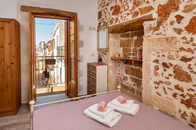 a room with two towels on a bed with a window at Casa Emily in Chania Town