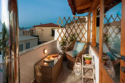 a balcony with a table and a chair on a balcony at Casa Emily in Chania Town
