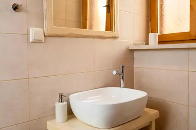 a bathroom with a white sink and a mirror at Casa Emily in Chania Town