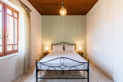 a bedroom with a bed in a room with a window at Femina in Pírgos Psilonérou