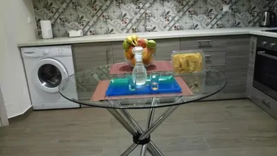 a glass table with a vase on it in a kitchen at Sofia's view Kissamos in Kissamos