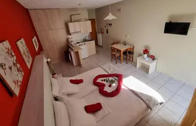 an aerial view of a room with a bed and a kitchen at Steps From The Beach Aprt in Chania Town