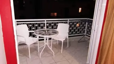 a glass table and chairs on a balcony at Steps From The Beach Aprt in Chania Town
