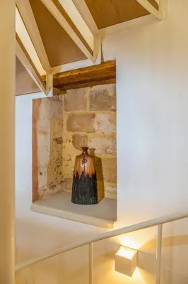 a fireplace in a room with a stone wall at Aelios Design Hotel in Chania Town