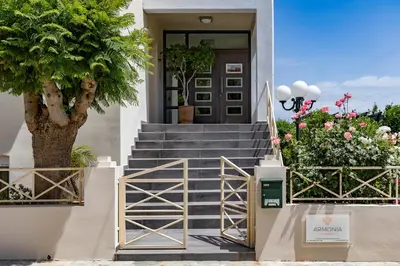 a staircase leading to a house with a door and flowers at Armonia Apartments in Almirida