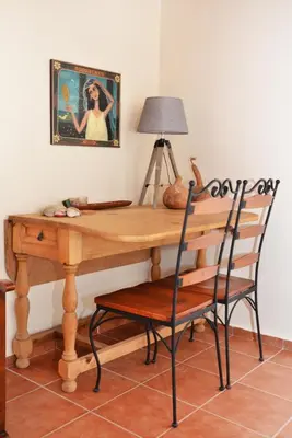 a wooden desk with a chair and a lamp at Villa Avly in Maleme