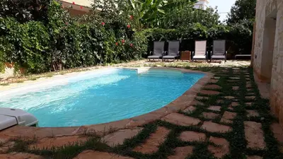 a swimming pool with chairs in a yard at Villa Avly in Maleme