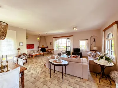 a large living room with couches and tables at Villa Avly in Maleme