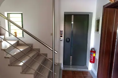 a staircase with a glass door and a fire extinguisher at Plumi City Apartments in Chania Town