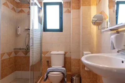 a bathroom with a toilet and a sink at Plumi City Apartments in Chania Town