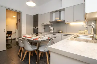 a kitchen with a table with chairs and a sink at Evridiki's House Central Chania in Chania Town