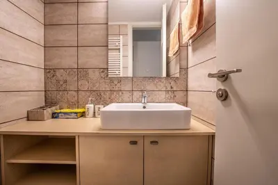 a bathroom with a sink and a mirror at Evridiki's House Central Chania in Chania Town