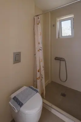 a bathroom with a toilet and a shower at Poseidon Studios & Apartments in Palaiochóra