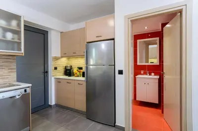 a kitchen with a stainless steel refrigerator at Villa Thalia in Stalos